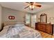 Bedroom with hardwood floors, a window, dresser and comfortable bed at 3229 Richwood Dr, Duluth, GA 30096