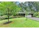 Charming home on a lush green lawn with mature trees, manicured landscaping and a welcoming driveway at 3229 Richwood Dr, Duluth, GA 30096