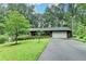 Charming ranch home with well-manicured lawn, mature trees, and long driveway leading to a two-car garage at 3229 Richwood Dr, Duluth, GA 30096