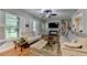 Open living room with hardwood floors, a stylish sofa, and large windows for a bright and airy atmosphere at 3229 Richwood Dr, Duluth, GA 30096