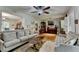 Inviting living room with hardwood floors, a ceiling fan, and comfortable seating for relaxation and entertaining at 3229 Richwood Dr, Duluth, GA 30096