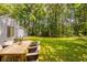 Spacious backyard perfect for outdoor entertaining with a dining set and lush green lawn at 6200 Beaver Creek Trl, Atlanta, GA 30349