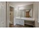 Bathroom featuring vanity with sink and a shower with carpet flooring beyond at 6200 Beaver Creek Trl, Atlanta, GA 30349