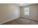 This carpeted bedroom offers a window with blinds for natural light at 6200 Beaver Creek Trl, Atlanta, GA 30349
