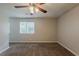 Bedroom featuring a ceiling fan and carpeted floor with a bright window at 6200 Beaver Creek Trl, Atlanta, GA 30349