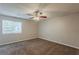 Bedroom featuring a ceiling fan, carpeted floor and bright window at 6200 Beaver Creek Trl, Atlanta, GA 30349