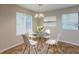 Bright dining area with a modern table set, large windows and stylish light fixture at 6200 Beaver Creek Trl, Atlanta, GA 30349