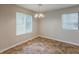 Dining area with tile flooring, bright chandelier, and sunny windows at 6200 Beaver Creek Trl, Atlanta, GA 30349