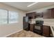 Functional kitchen with dark cabinets, modern appliances, and plenty of natural light at 6200 Beaver Creek Trl, Atlanta, GA 30349