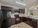 Well-lit kitchen featuring dark cabinets, modern appliances, and a convenient layout at 6200 Beaver Creek Trl, Atlanta, GA 30349