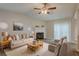 Bright living room featuring a cozy fireplace, plush seating, and sliding glass door with backyard views at 6200 Beaver Creek Trl, Atlanta, GA 30349