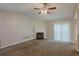 Spacious living room featuring a fireplace, ceiling fan and carpeted floor at 6200 Beaver Creek Trl, Atlanta, GA 30349