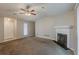 Cozy living room with a fireplace, ceiling fan, and neutral carpet at 6200 Beaver Creek Trl, Atlanta, GA 30349
