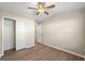 Neutral bedroom with hardwood floors, closet, ceiling fan and access to a bathroom at 213 Riverstone Commons Cir, Canton, GA 30114