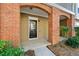 Townhome entryway with brick accents and a black front door and manicured landscaping at 213 Riverstone Commons Cir, Canton, GA 30114