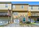 Rear exterior view of townhome with garage and wooden deck at 213 Riverstone Commons Cir, Canton, GA 30114