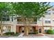 Charming townhome with brick accents, balcony, lush landscaping and inviting entryways at 213 Riverstone Commons Cir, Canton, GA 30114
