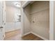 Hallway with closet, access to an exterior door, and hardwood floors at 213 Riverstone Commons Cir, Canton, GA 30114