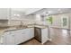 Kitchen and living room with wood flooring and neutral paint at 213 Riverstone Commons Cir, Canton, GA 30114