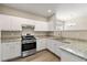 Kitchen with granite countertops, stainless steel appliances and white cabinets at 213 Riverstone Commons Cir, Canton, GA 30114