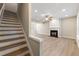 Open living room with hardwood flooring, fireplace, and staircase at 213 Riverstone Commons Cir, Canton, GA 30114