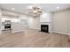 Living room with a fireplace, kitchen, and an open floor plan at 213 Riverstone Commons Cir, Canton, GA 30114