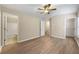 Spacious main bedroom featuring hardwood flooring, fan, walk-in closet, and ensuite bathroom at 213 Riverstone Commons Cir, Canton, GA 30114