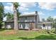View of the backyard featuring a lawn, gray exterior, trees, and partial fence at 2849 Snapfinger Rd, Decatur, GA 30034