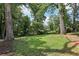 Expansive backyard featuring mature trees with grassy area, perfect for outdoor activities at 2849 Snapfinger Rd, Decatur, GA 30034