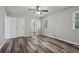 A bright bedroom with wood-look floors, neutral paint, and a ceiling fan at 2849 Snapfinger Rd, Decatur, GA 30034
