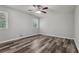 Bright bedroom with wood-look floors, neutral paint, and two windows at 2849 Snapfinger Rd, Decatur, GA 30034