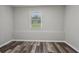 This bedroom has gray walls, wood-look flooring, and a window providing natural light at 2849 Snapfinger Rd, Decatur, GA 30034