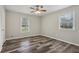 This bedroom boasts natural light, wood-look floors, neutral paint, and a ceiling fan at 2849 Snapfinger Rd, Decatur, GA 30034