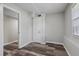 Bedroom featuring wood-look flooring, neutral walls, a window and a door leading to another room at 2849 Snapfinger Rd, Decatur, GA 30034