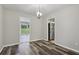 Dining room with wood-look floors, neutral walls, and views of kitchen and backyard at 2849 Snapfinger Rd, Decatur, GA 30034