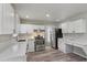 Modern kitchen features white cabinets, stainless steel appliances, and new countertops at 2849 Snapfinger Rd, Decatur, GA 30034