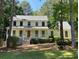 Inviting two-story home with a charming front porch and well-manicured lawn surrounded by mature trees at 340 Sherwood Se Cir, Conyers, GA 30094