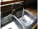 A double basin stainless steel sink features a gooseneck faucet and a water stream at 340 Sherwood Se Cir, Conyers, GA 30094