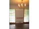 Bright living room featuring a golden chandelier and large windows providing ample natural light at 340 Sherwood Se Cir, Conyers, GA 30094