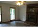Inviting living room with a wooden fireplace and ample natural light through the windows at 340 Sherwood Se Cir, Conyers, GA 30094
