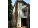 Side exterior view of a house with a brick chimney and a small balcony at 340 Sherwood Se Cir, Conyers, GA 30094
