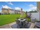 Spacious backyard with well-maintained lawn and a patio dining set at 44 Providence Oak Ct, Lawrenceville, GA 30046