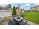 View of backyard with a patio dining set, green grass, and a privacy fence at 44 Providence Oak Ct, Lawrenceville, GA 30046