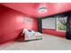 Unique red bedroom featuring a movie screen, large window, and lounge seating at 44 Providence Oak Ct, Lawrenceville, GA 30046