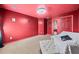 Spacious red bedroom with a textured ceiling, lounge seating and mirrored closet at 44 Providence Oak Ct, Lawrenceville, GA 30046