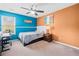 Bright bedroom featuring a ceiling fan, large windows, and colorful walls at 44 Providence Oak Ct, Lawrenceville, GA 30046