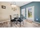 Cozy dining area features a glass table, black chairs, and access to the outdoors at 44 Providence Oak Ct, Lawrenceville, GA 30046