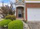 Close-up of the front entrance with a brick facade, a black door, and manicured landscaping at 44 Providence Oak Ct, Lawrenceville, GA 30046