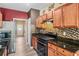 Galley kitchen with granite countertops, stainless steel appliances, and wood cabinets at 44 Providence Oak Ct, Lawrenceville, GA 30046