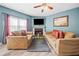 Living room showcases a fireplace, flat screen tv and two sofas with decorative pillows at 44 Providence Oak Ct, Lawrenceville, GA 30046
